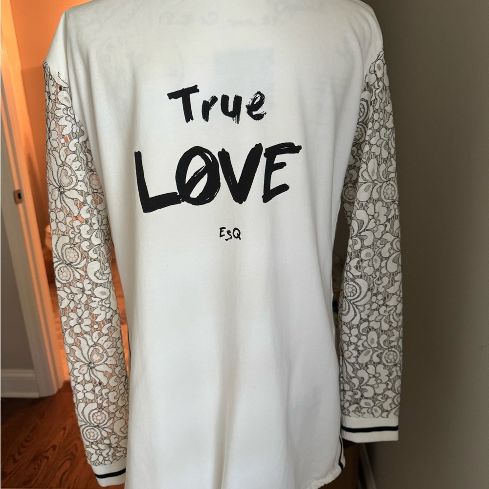 White jacket with lace sleeves and “true love” on the back
